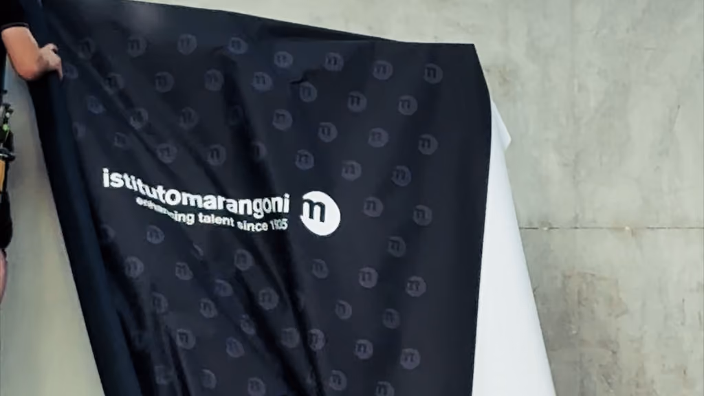 Bâche noire siglée Istituto Marangoni tendue en coulisses du défilé